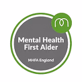 Badge with 'Mental Health First Aider' and 'MHFA England' text on gray background.