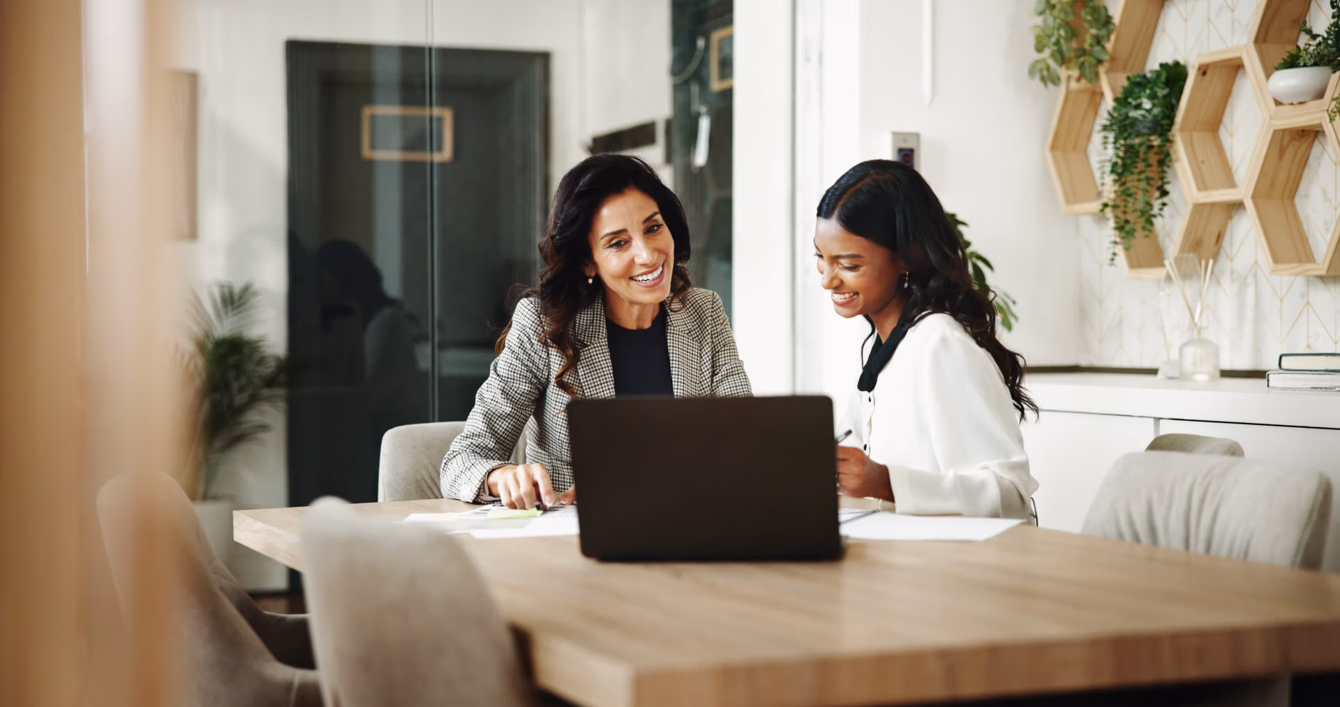 Two HR women working and smiling: How to Manage Staff Effectively in SMEs